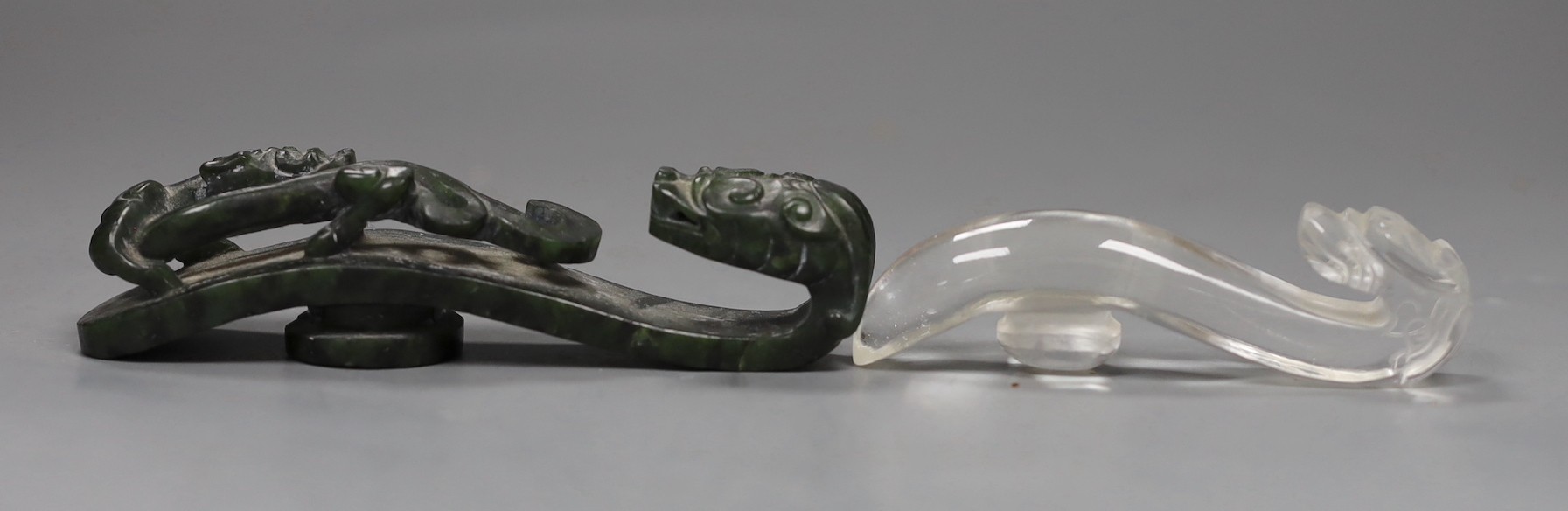 A Chinese rock crystal belt hook and a Chinese spinach green jade belt hook (2), largest 12cms long